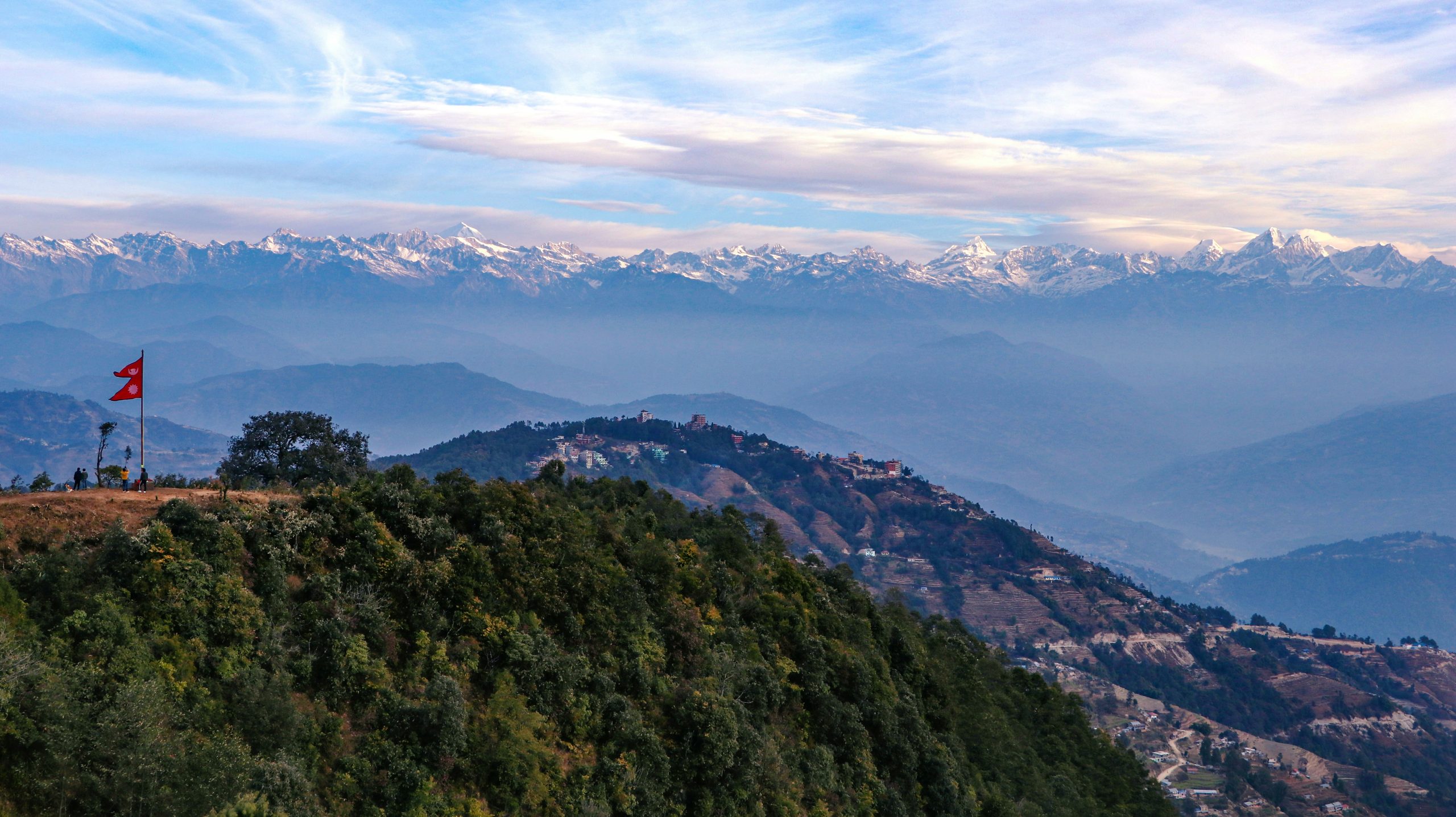 Scenic view of Nagarkot with lush greenery and Himalayan peaks, highlighting the Nagarkot Changunarayan Day Hike trail offering stunning landscapes and cultural experiences.
