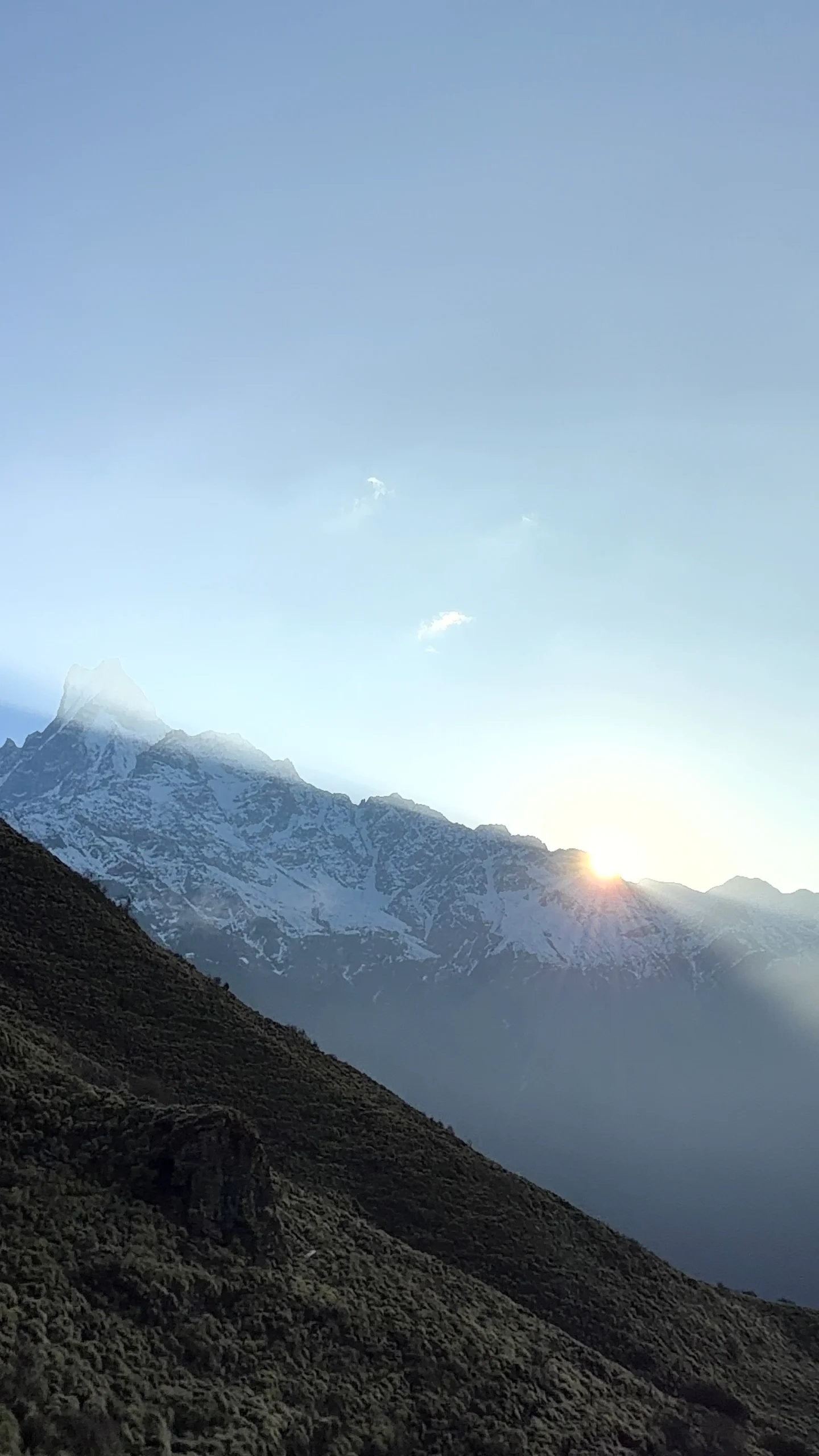 he sun rising over the snow-capped peak of Mount Machapuchare (Fishtail Mountain) as seen from the Mardi Himal trek route.