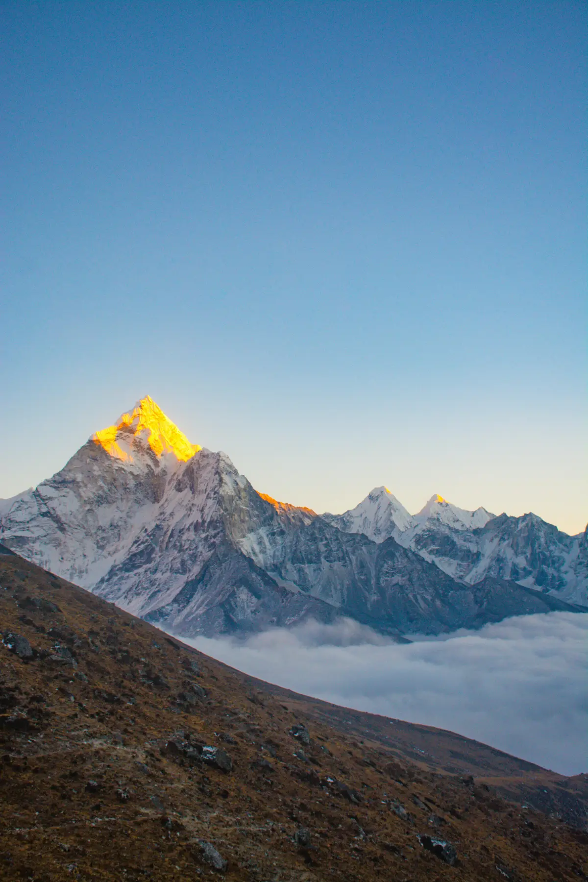 "Golden sunrise on snow-covered Himalayan peaks near Everest Base Camp, a breathtaking view that welcomes adventurers returning to trekking in Nepal after COVID."