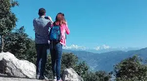 Trekkers walking through forests on the Chisapani Nagarkot trek with mountain views.