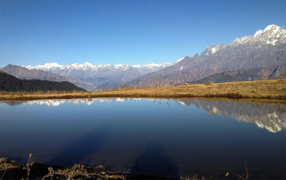 Parvati Kunda lake with mountains in the background seen in Tamang Heritage Trail trek.